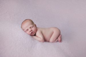 newborn baby photo pose curled up pink