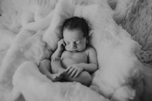 newborn baby photography curled up black white