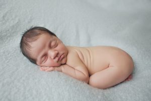 newborn baby photography posed curled up pose blue