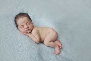 newborn baby photography posed pose curled up blue