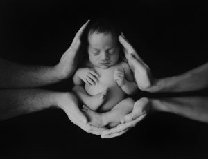 newborn baby photography blakc white curled up hands