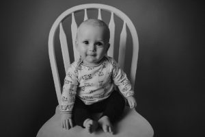 sitting baby photography black white chair