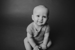 sitting baby photography black white