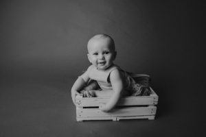 sitting baby photography black white
