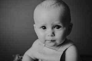 sitting baby photography black white