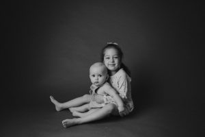 sibling baby photography black white