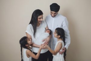 sibliing baby sikh girls boy newborn holding cream