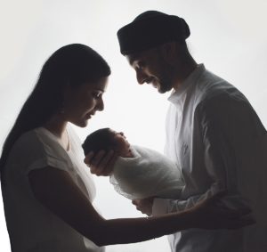 sibliing baby sikh girls boy newborn holding cream parents mum dad backlit