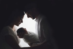 sibliing baby sikh girls boy newborn holding cream parents mum dad backlit