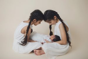 sibliing baby sikh girls boy newborn holding cream