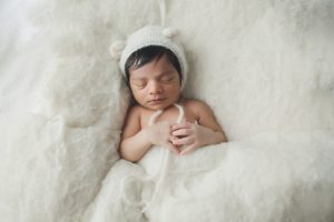 baby newborn photography cream bear hat boy curled up pose natural