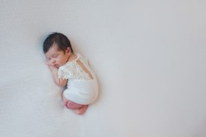 newborn baby outfit lace curled up posed ivory