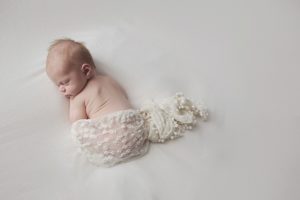 natural newborn baby photography cream curled pose wrap
