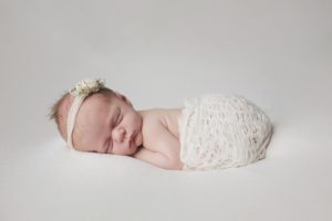 natural newborn baby photography cream curled pose