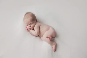 natural newborn baby photography cream curled pose