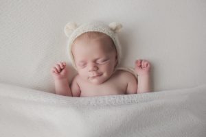 natural newborn baby photography cream curled pose bear hat
