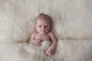 natural newborn baby photography cream curled pose natural smile wind