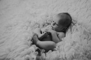natural relaxed black white newborn baby photography curled posed pose