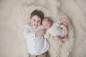 sibling newborn photography toddler cream cuddle
