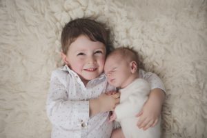 sibling newborn photography toddler cream cuddle