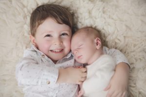 sibling newborn photography toddler cream cuddle
