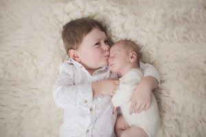 sibling newborn photography toddler cream cuddle
