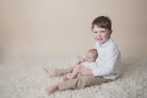 sibling newborn photography toddler cream cuddle