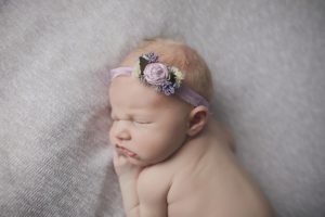 newborn baby girl with lavender floral headband