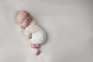 newborn baby girl lace outfit cream curled up