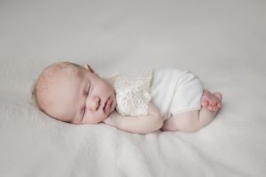 newborn baby girl lace outfit cream curled up