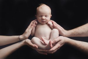 newborn baby girl hands parents