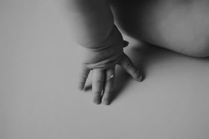 black and white hand shot baby photography