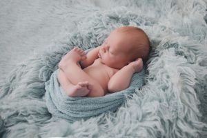 newborn baby photography grey blue boy rug flokati wrapped curled up